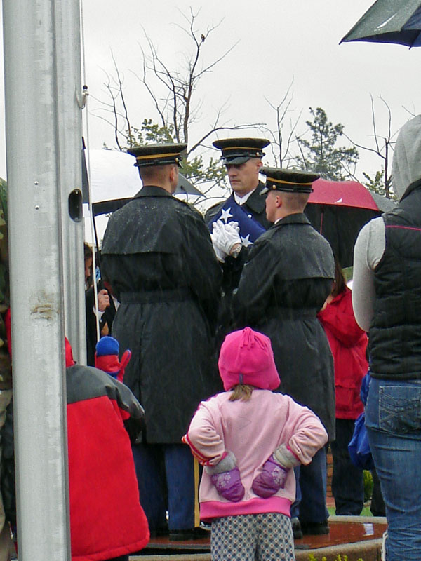 Children watch the honor guard, prepare to raise the flag