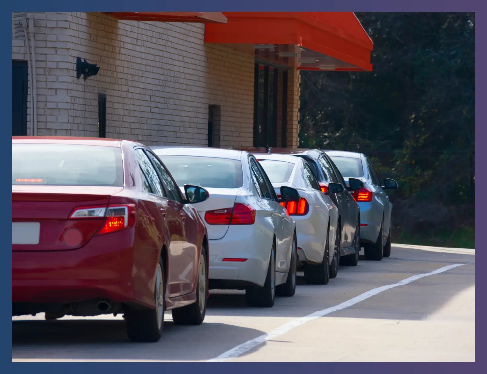 An image of cars in line at a fast food drive-thru
