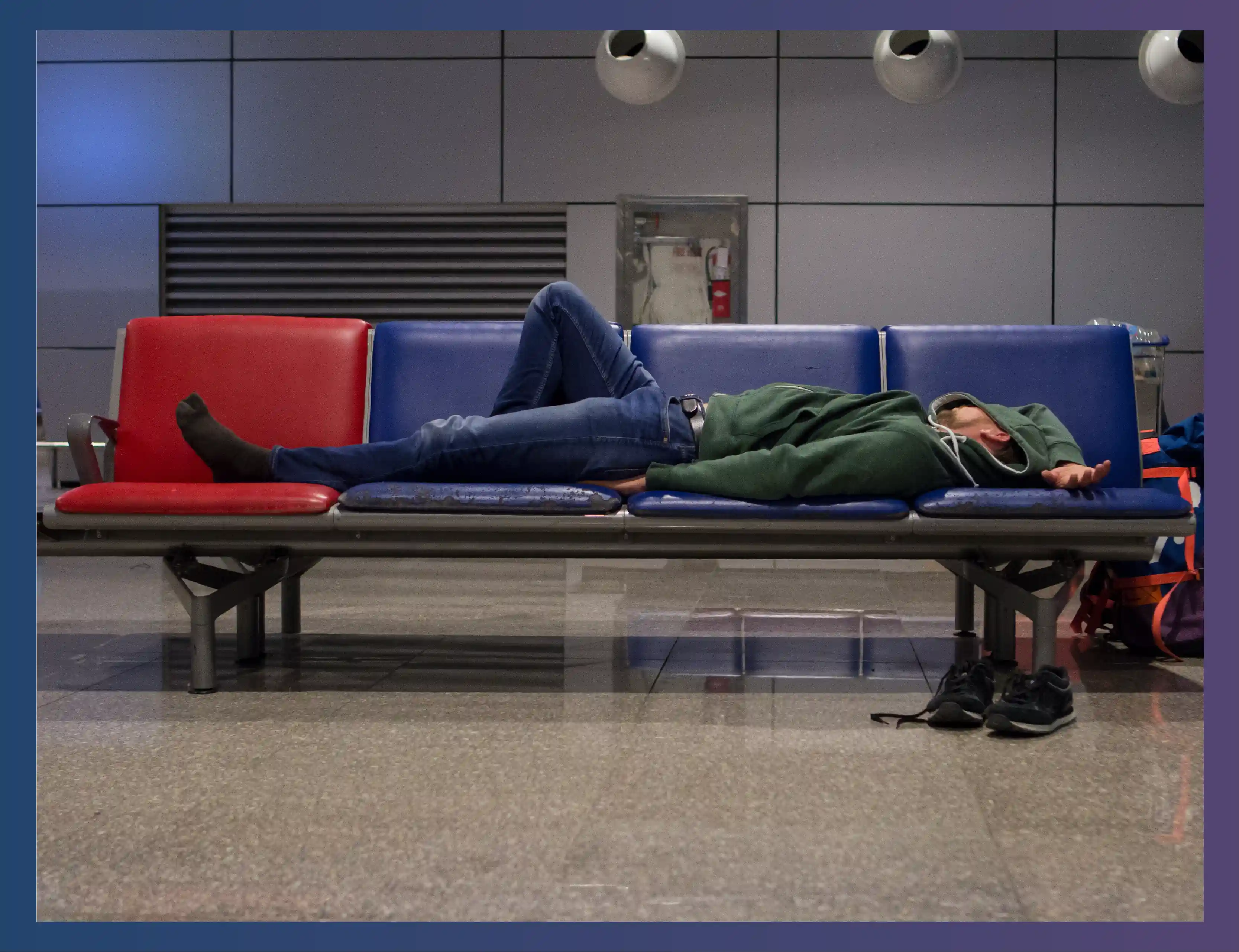 An image of a person laying on seats at an airport