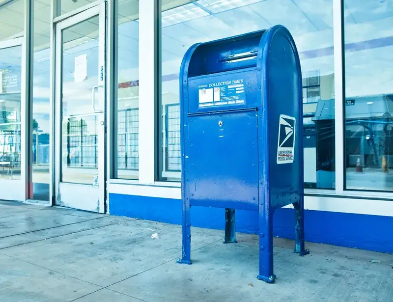 An image of a mail box outside of a post office